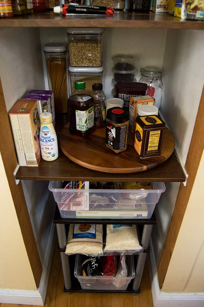 An organized pantry shelf with a rotating tray.