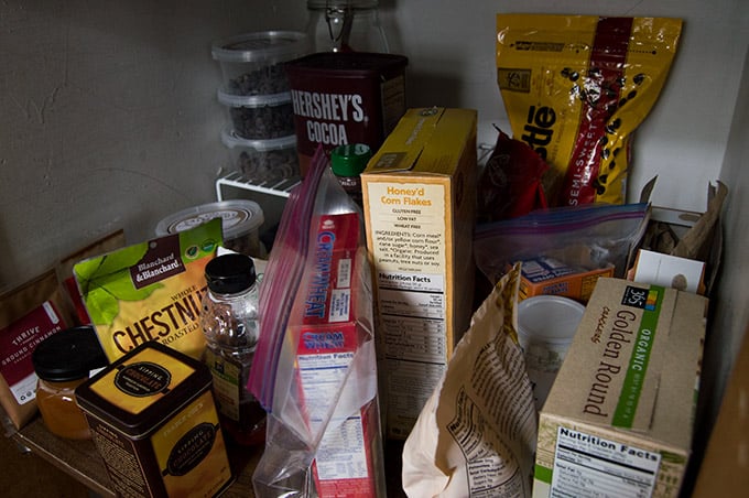 Closeup of disorganized pantry items on a shelf.