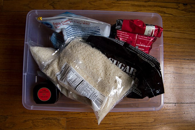 A plastic bin of pantry items.