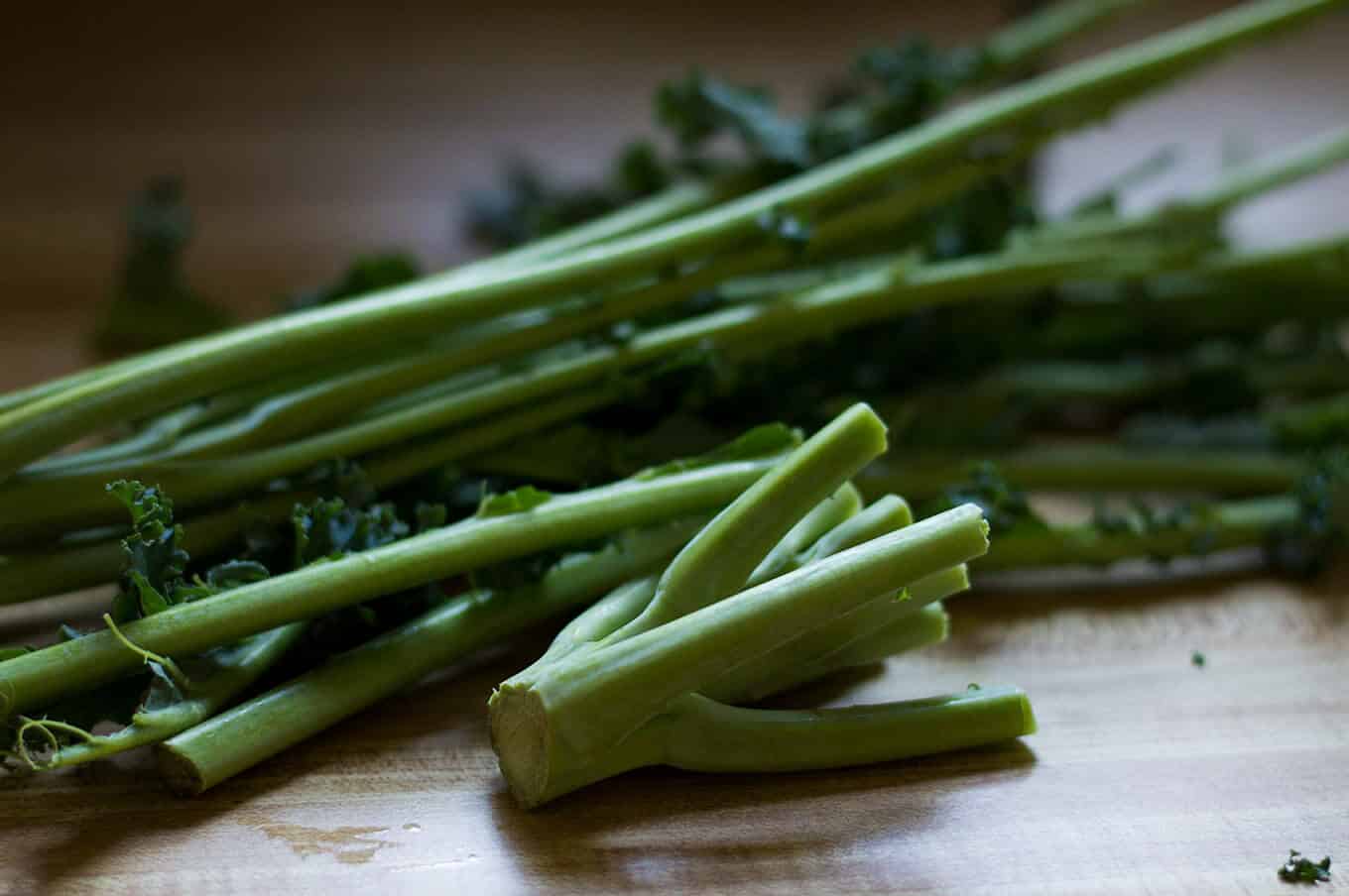 Closeup of kale stems on a countertop.