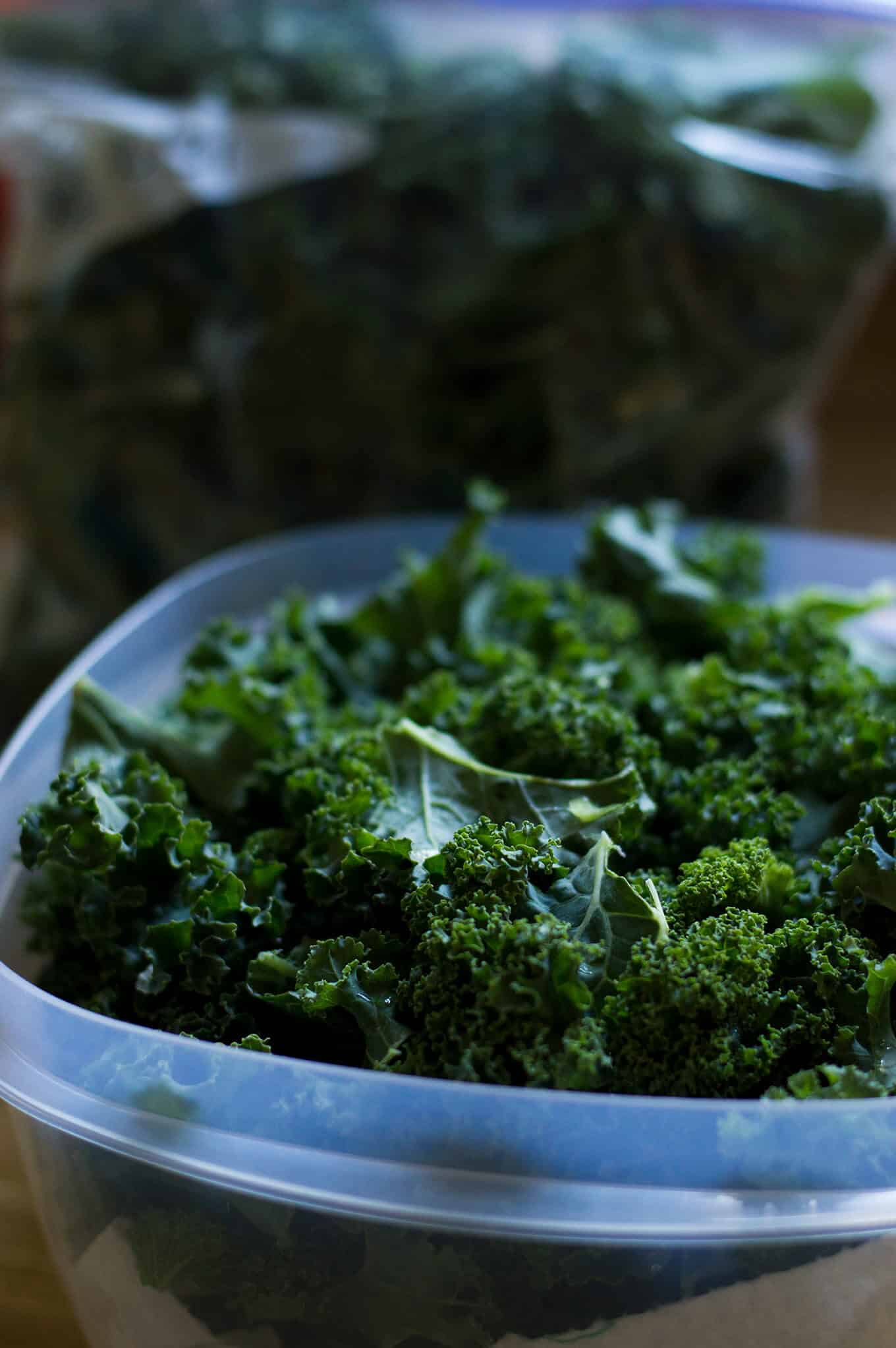 A close up of kale in a food storage container.