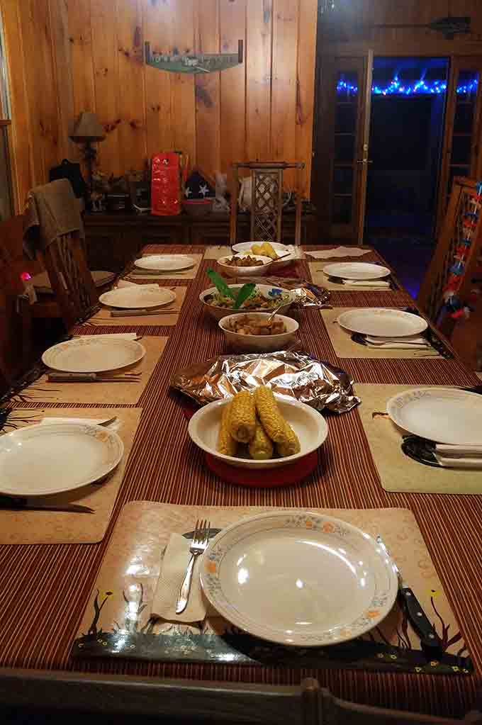 A dining room table set with plates and food.