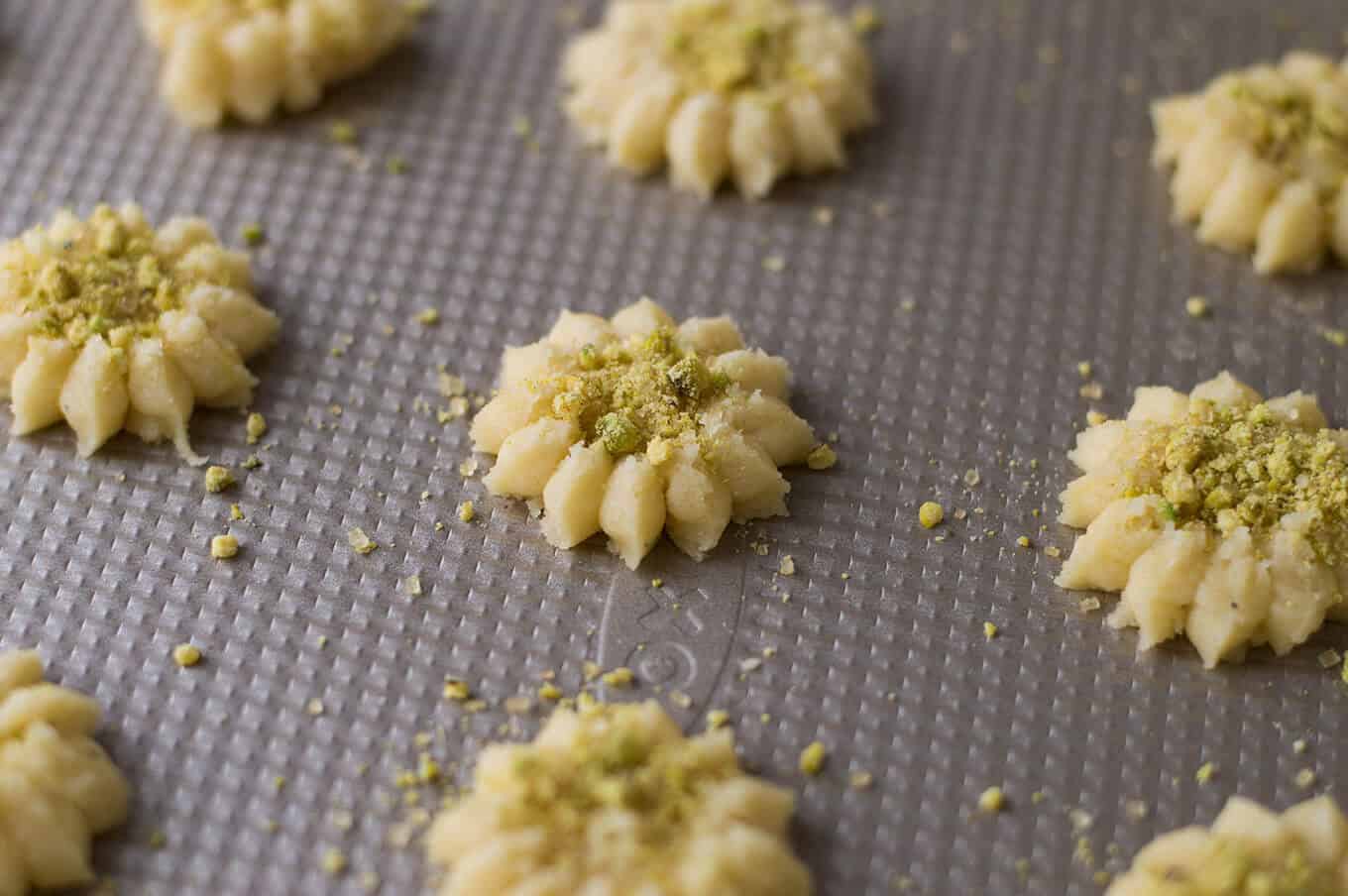 Pressed cookie dough on a baking sheet.