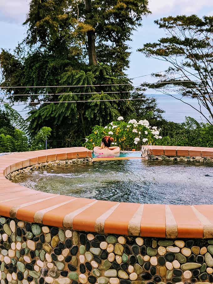 A person in a pool with trees in the background.