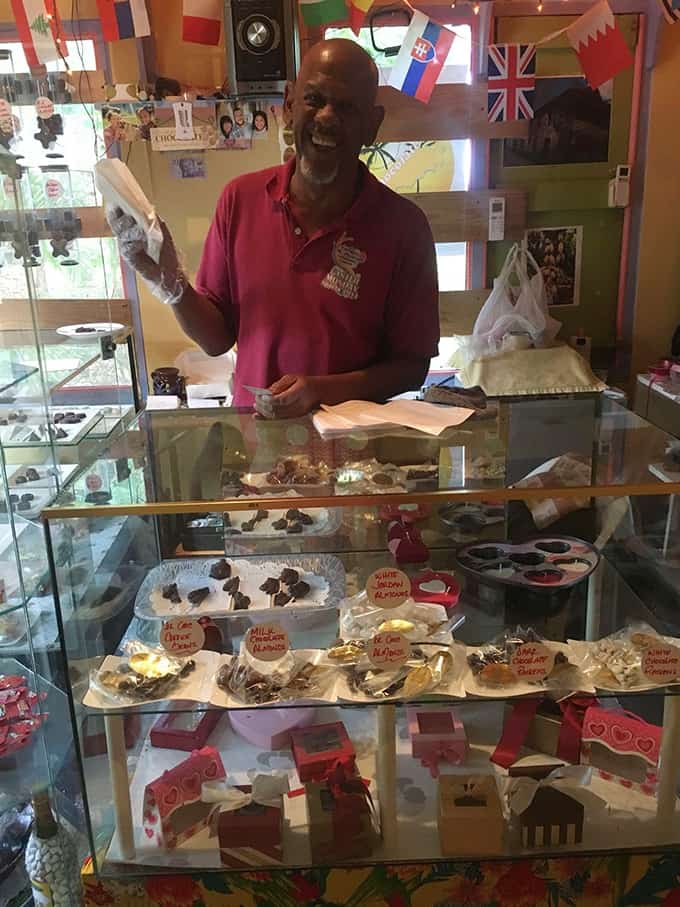 A person holding a bag of chocolates in a specialty chocolate store.