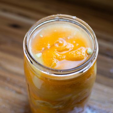 A mason jar of homemade preserved lemons.