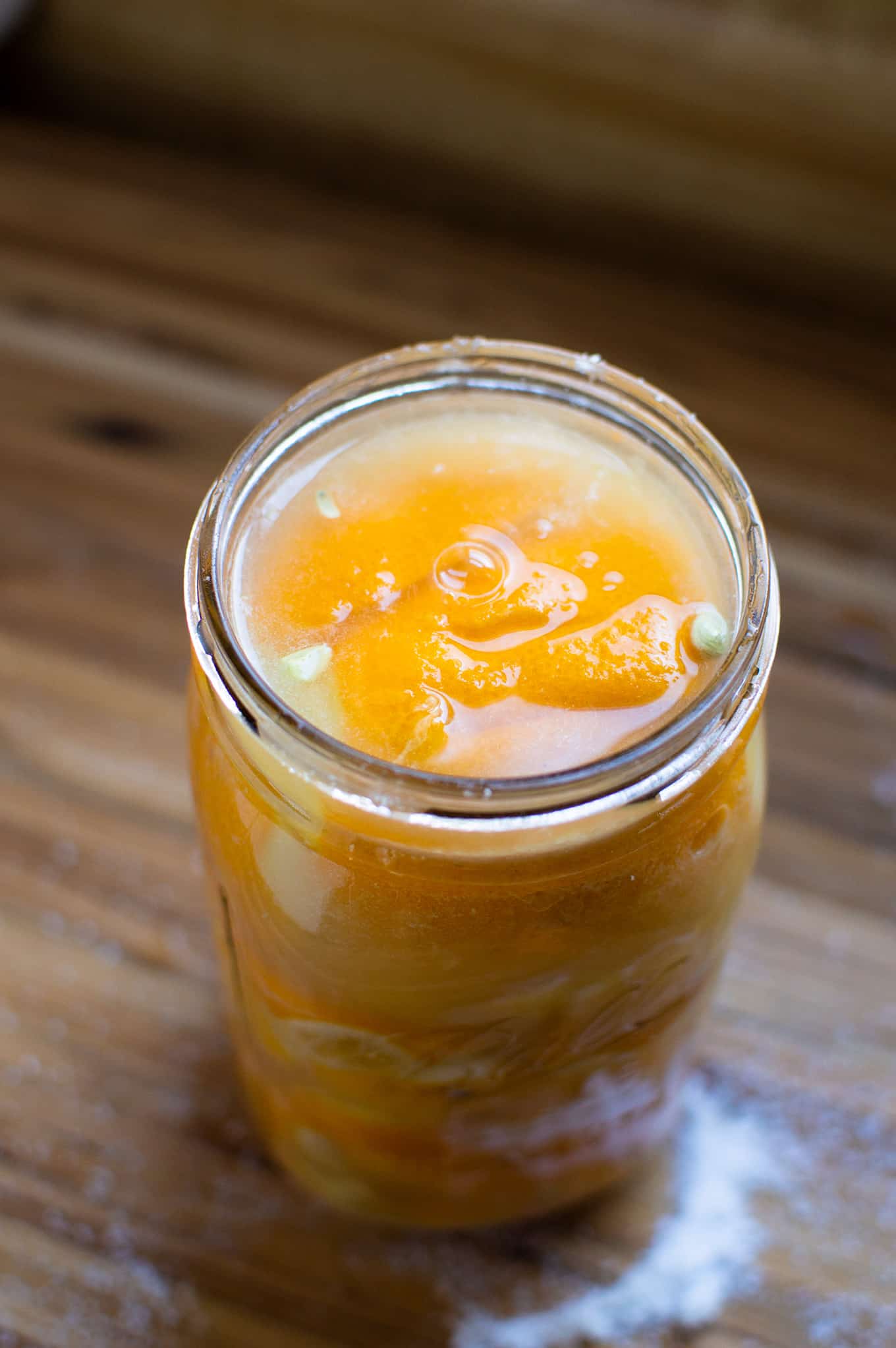 A mason jar of homemade preserved lemons.