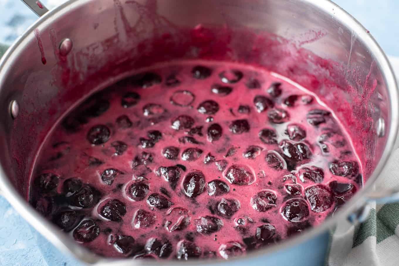 A saucepan of prepared cherry preserves.