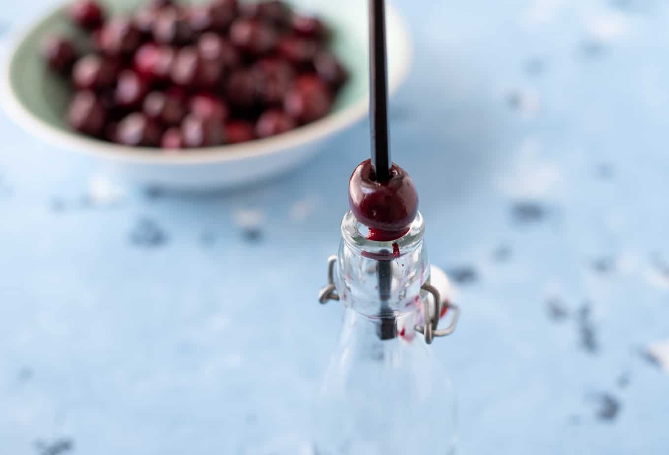 A cherry on a bottle top with a stick through it to remove the pit.