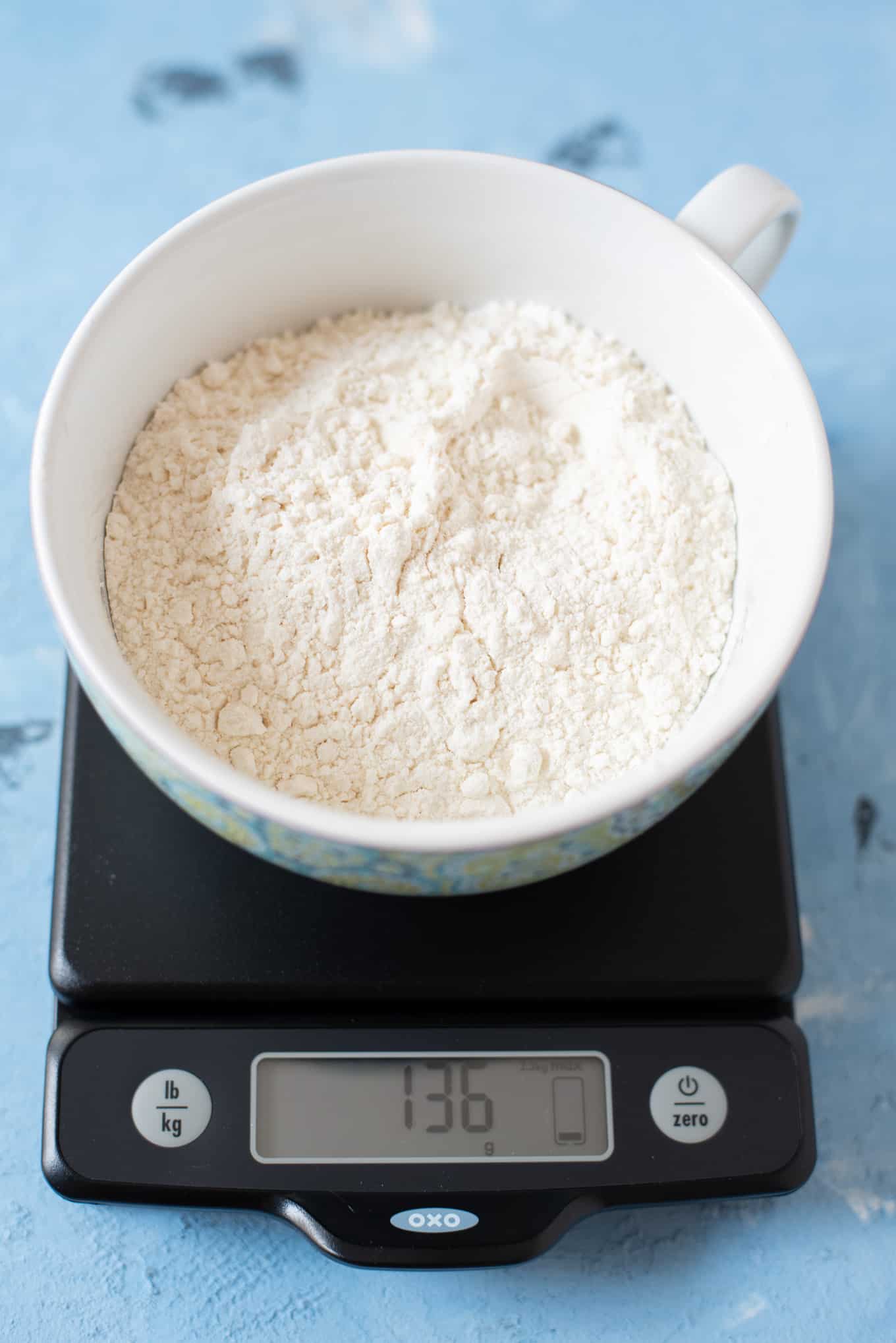 A bowl of flour on a food scale.