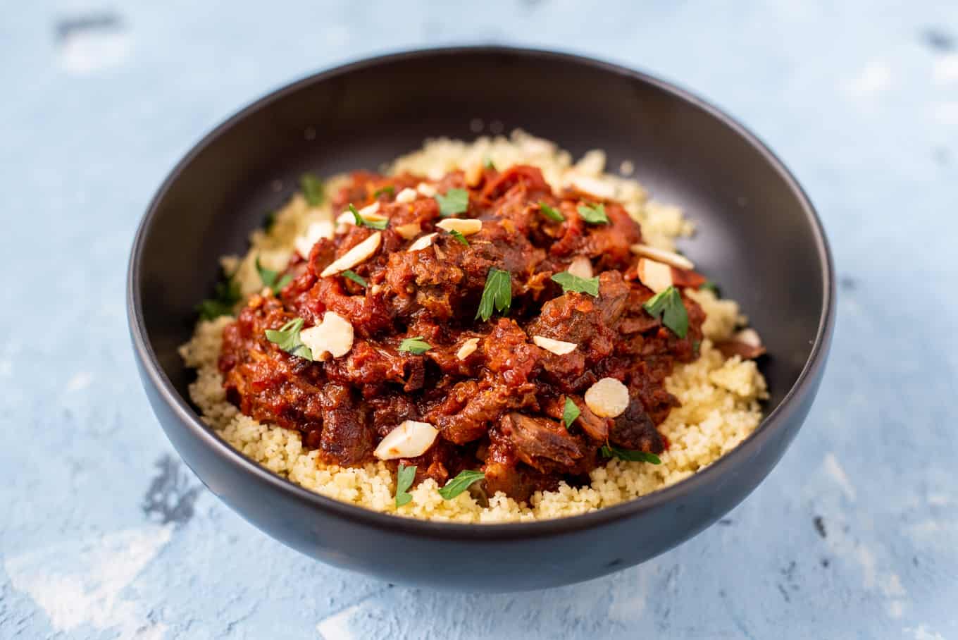 A close-up of lamb tagine in a bowl.