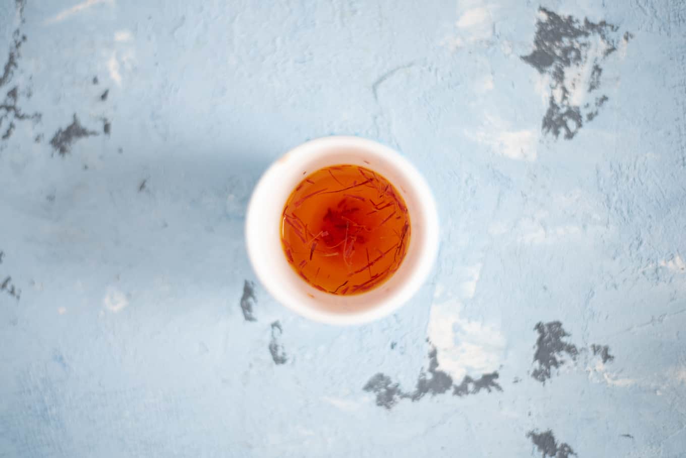 A small bowl of saffron in water.
