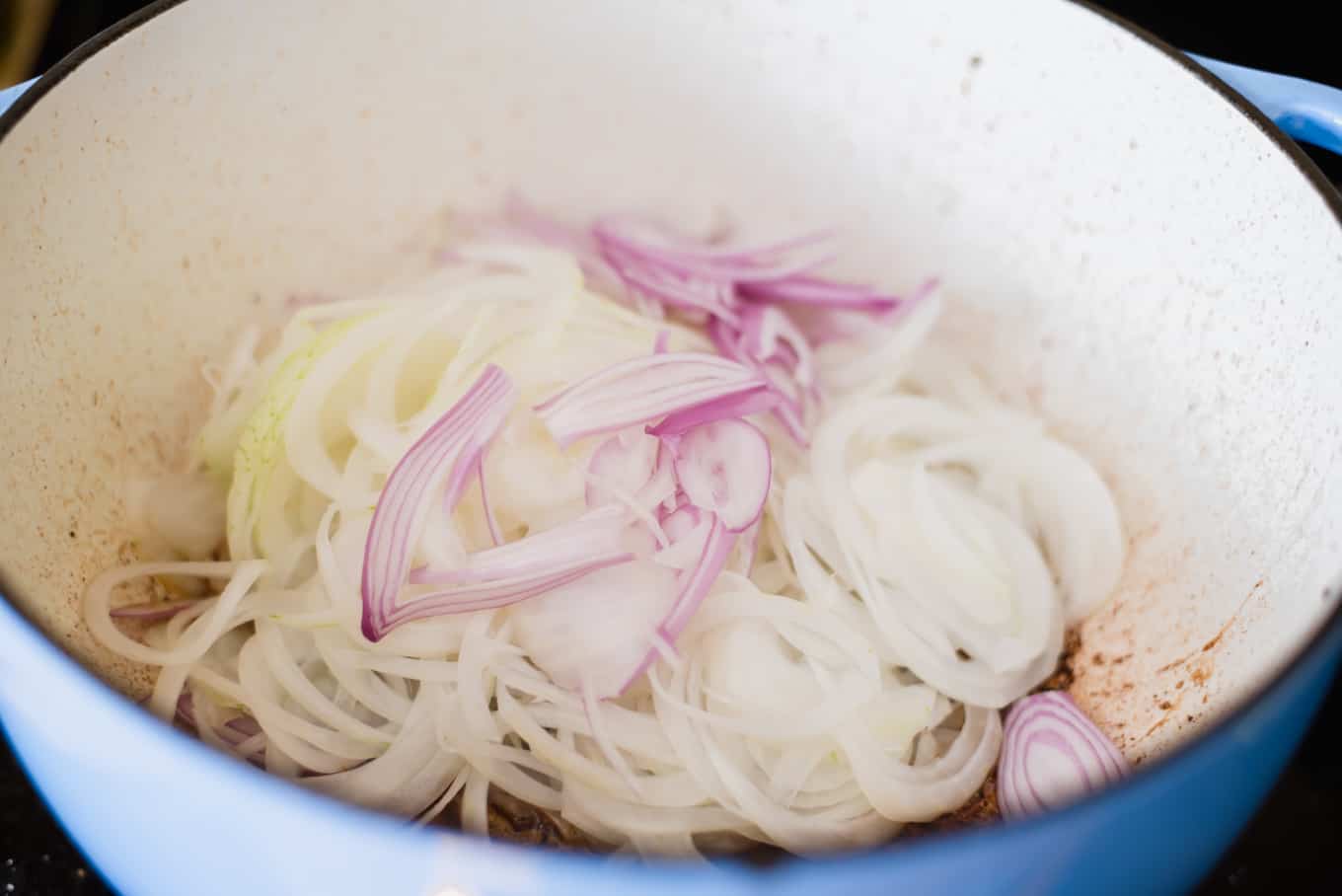 Sliced onions in a dutch oven.