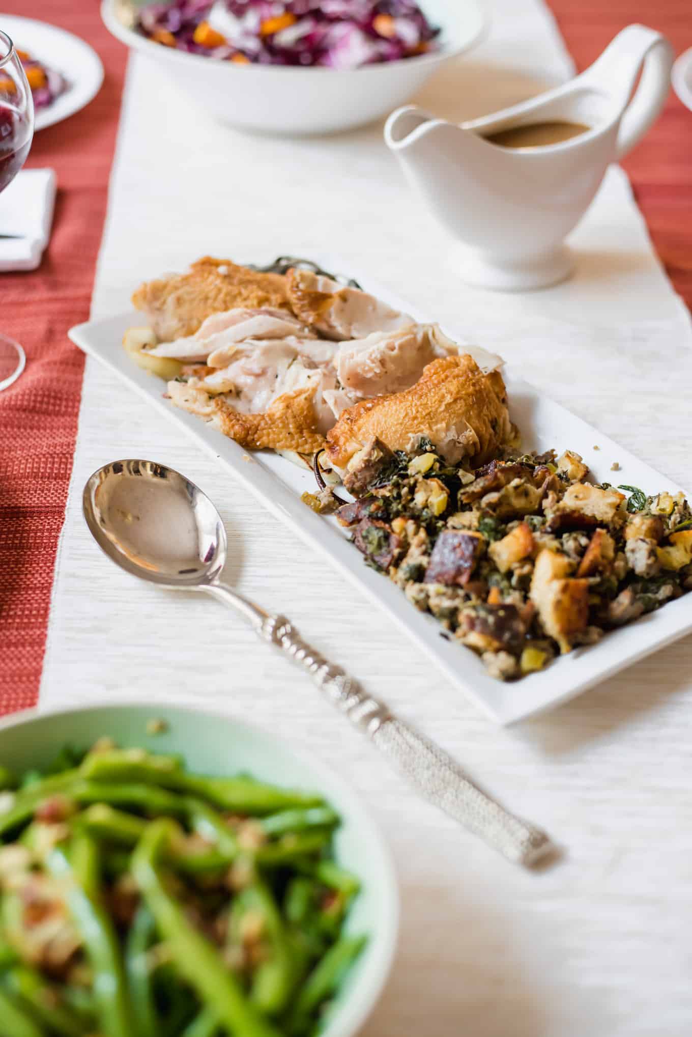 A plate of roasted turkey and stuffing on a table.