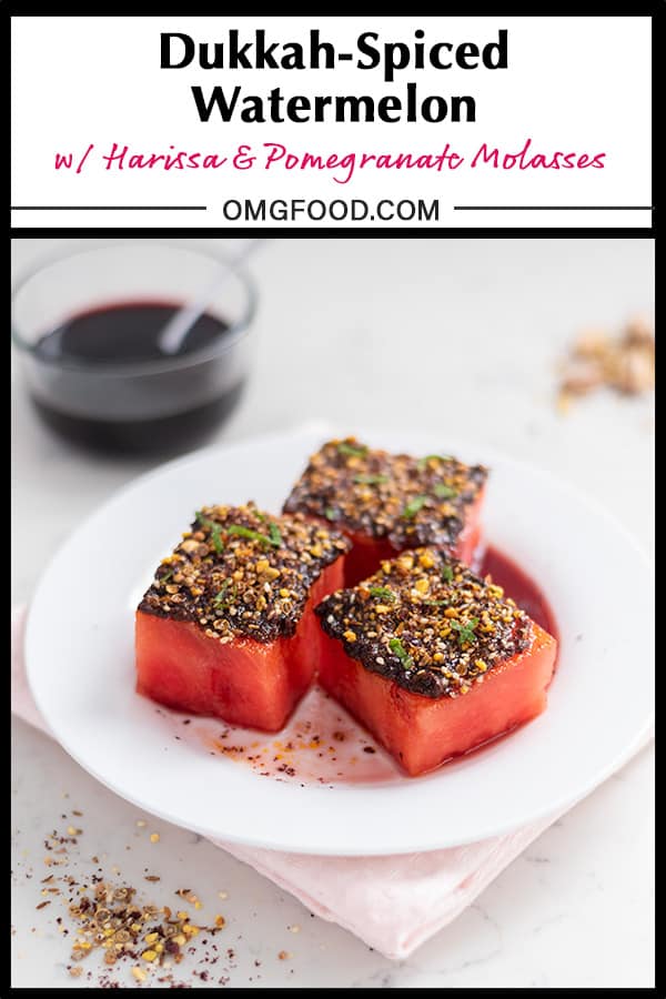 Watermelon topped with harissa, dukkah, and mint with pomegranate molasses in the background.