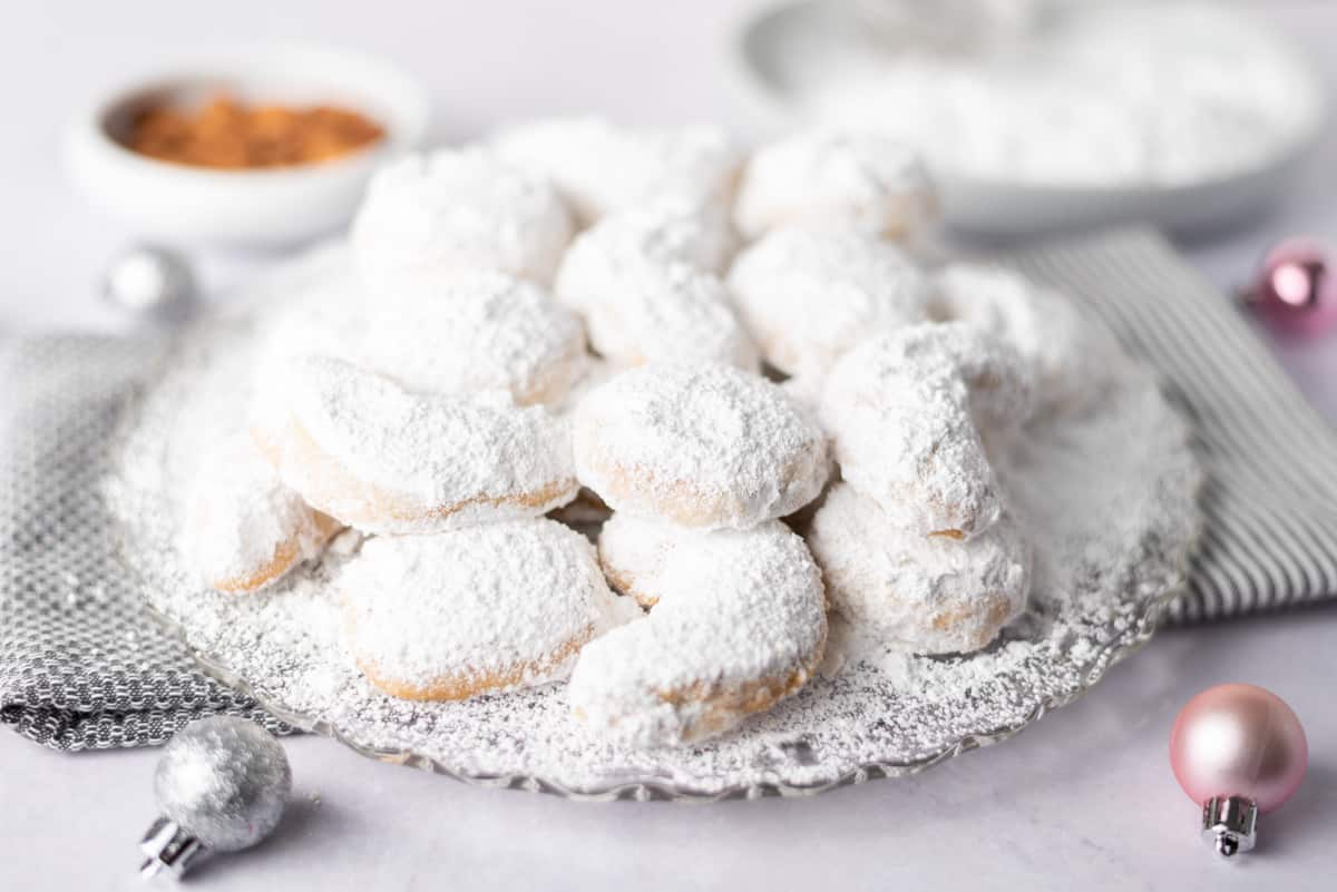 A platter of cookies covered with powdered sugar.