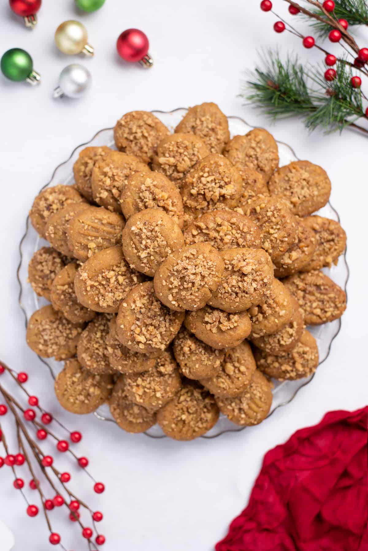 A platter of Greek honey cookies and small ornaments on a tabletop.