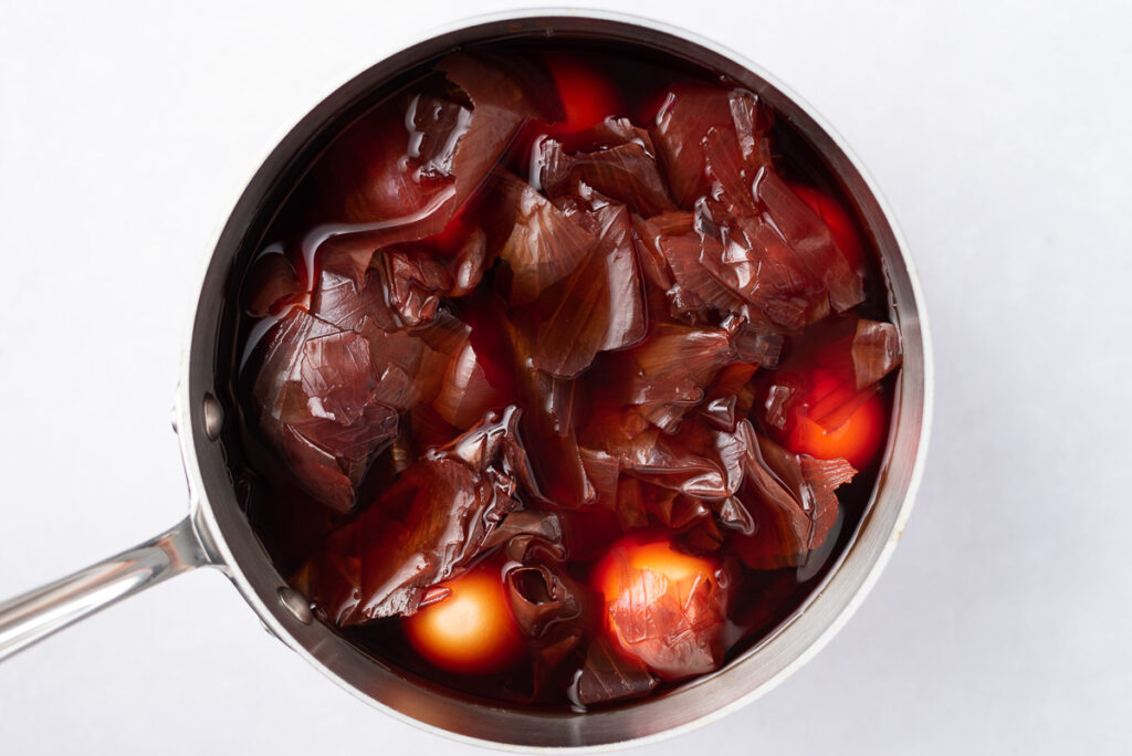 Eggs and onion skins in a pot of natural dye.