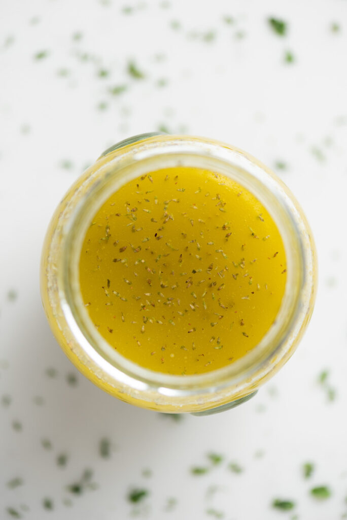 Top view of ladolemono dressing in a jar.